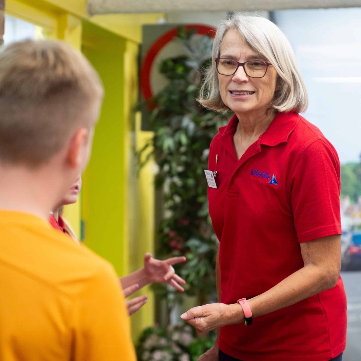 A Life Skills volunteer interacting with children.